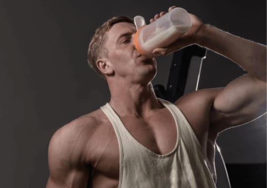 A man drinking pre-workout supplement.