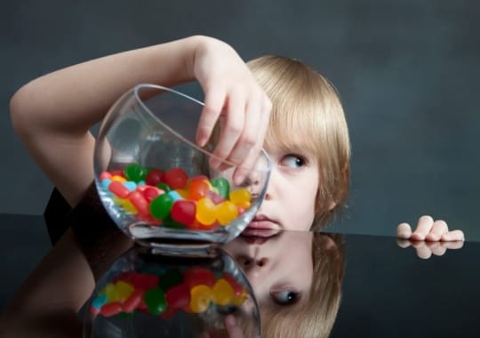 A child with gummies.