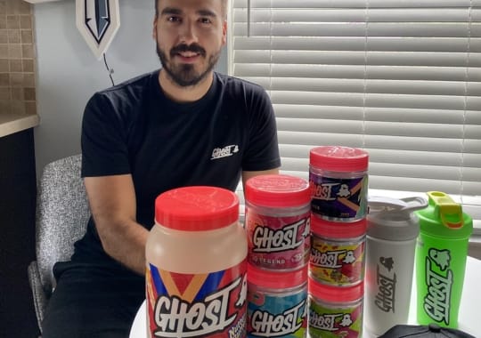 A man with different types of ghost pre-workout supplement.