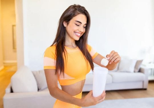 A woman making protein supplement.