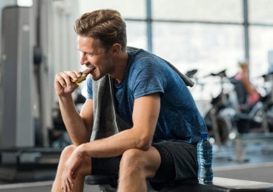 A man eating optimum nutrition cookies.