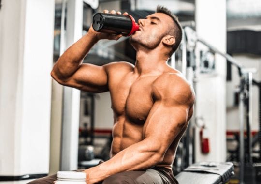 A man drinking pre workout supplement.