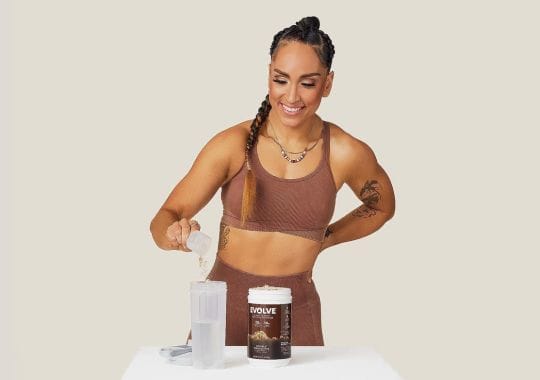 A woman making protein shake.