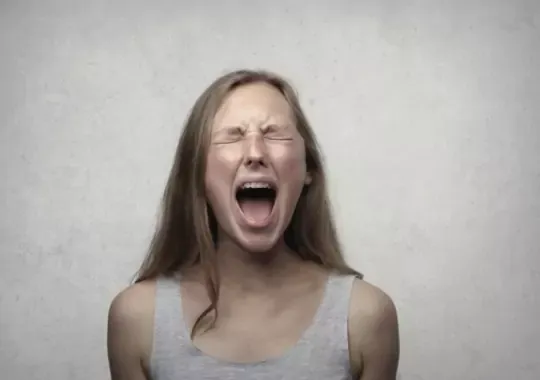 A lady screaming out of anger.