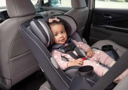 A baby put in a rotating car seat.