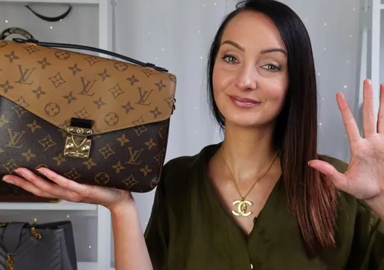 A young woman holding a lv bag.
