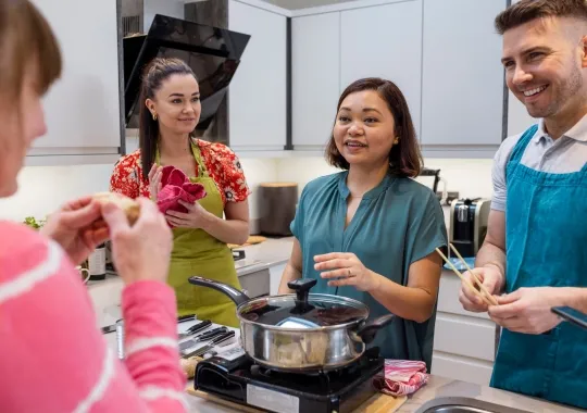 Group of mixed ethnicity and age people participating in a cooking class.