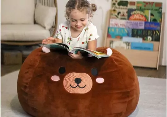 A little girl with a Squishmallow.