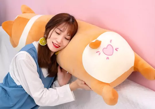 A woman leaning a Squishmallow.