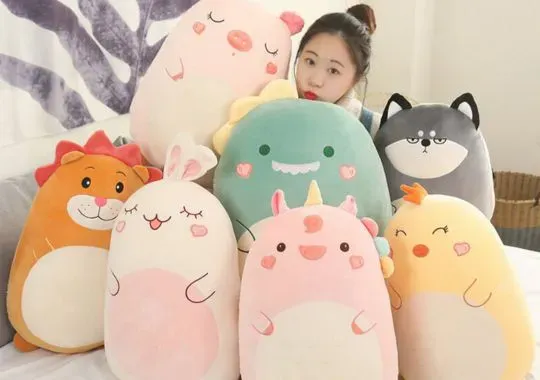 A girl with Different types of Squishmallows.