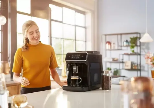 A woman using a Coffee machines.
