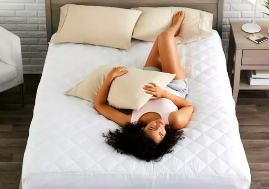 A woman laying on the Utopia mattress.