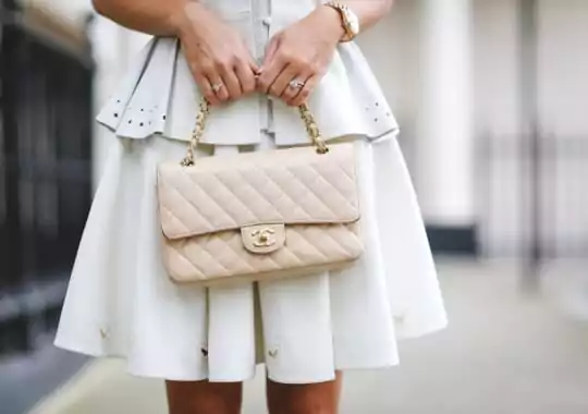 A woman holding a chanel bag.